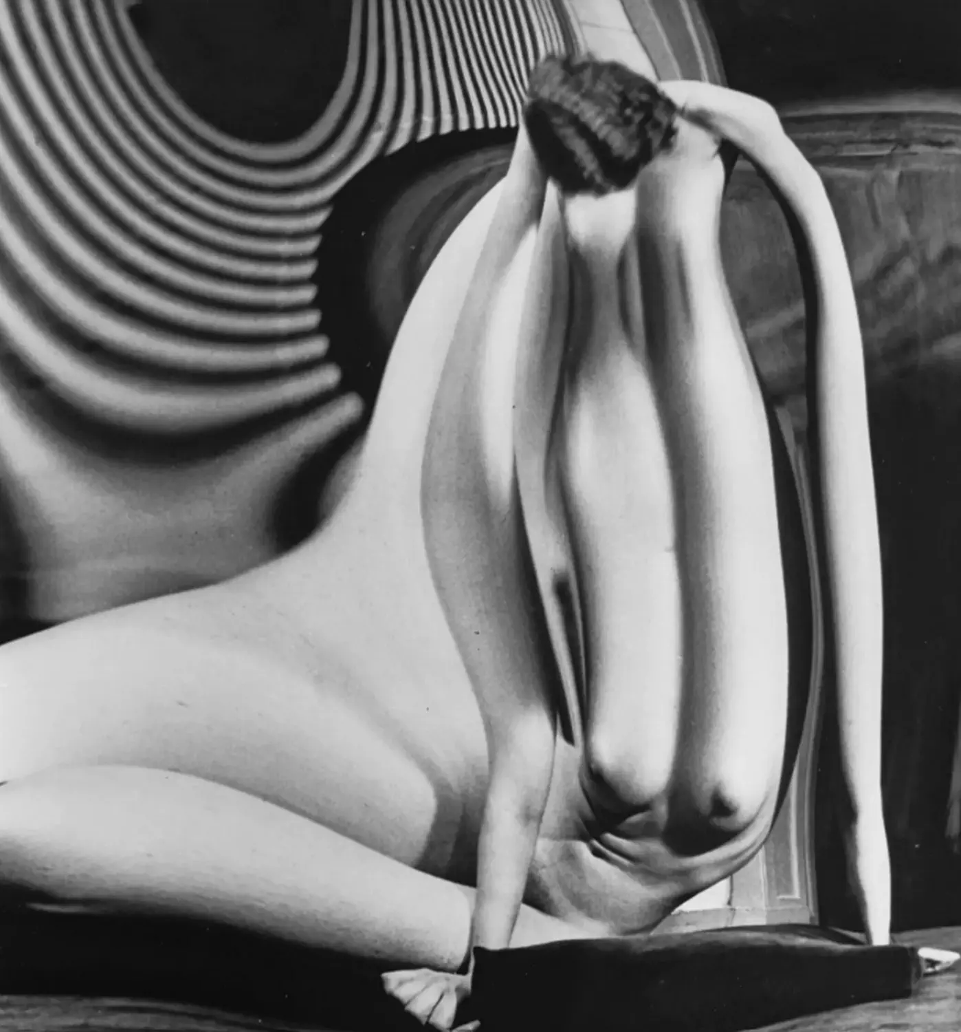 An example from André Kertész's Distortions series, showing a nude reflected in a curved mirror.